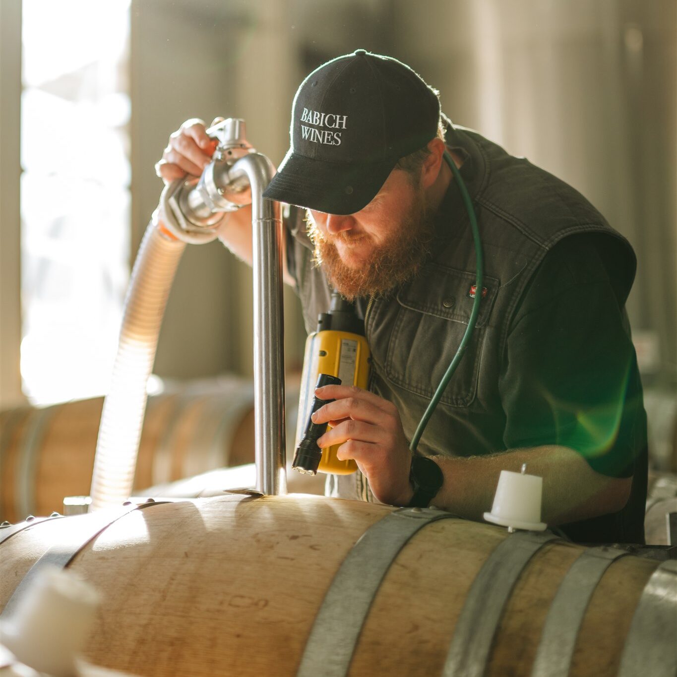 Babich Wine Marlborough Team Member working with New Zealand Fermenting Barrel